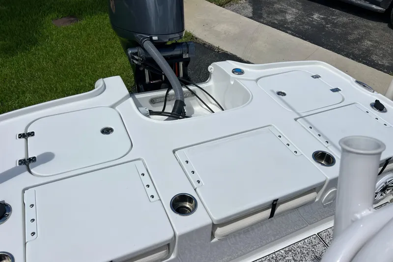 Slide: The Image of 2024 Sea Hunt BX 22 BR boat deck with storage compartments and motor. - 19