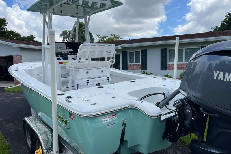 Slide: The Image of 2024 Sea Hunt BX 22 BR boat with Yamaha engine on trailer, parked in driveway. - 8