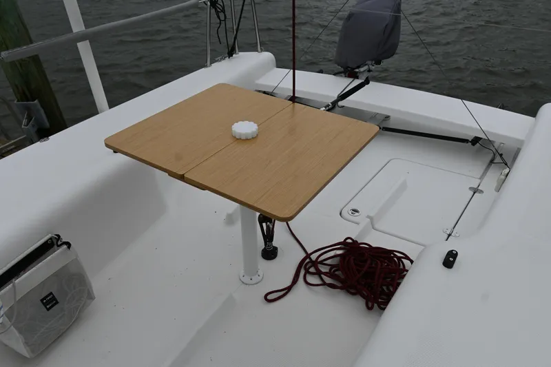 Slide: The Image of Cockpit of 2022 Beneteau First 24 sailboat with wooden table and red rope. - 12