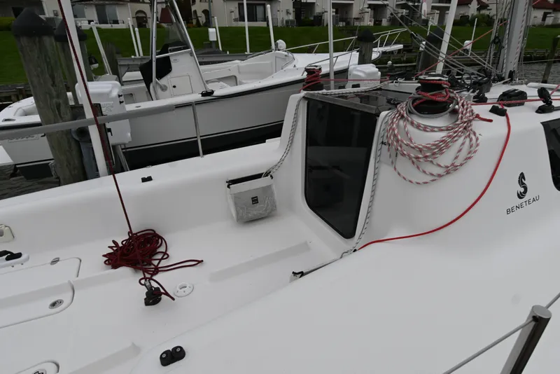 Slide: The Image of 2022 Beneteau First 24 sailboat docked, featuring sleek design and coiled ropes on deck. - 14