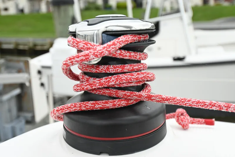 Slide: The Image of Red rope wrapped around a winch on a 2022 Beneteau First 24 sailboat. - 17