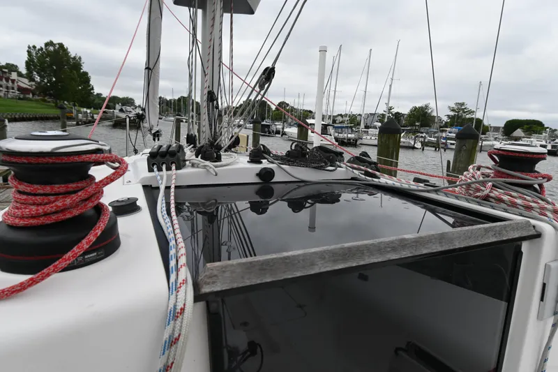 Slide: The Image of 2022 Beneteau First 24 sailboat docked, showcasing deck rigging and winches. - 19