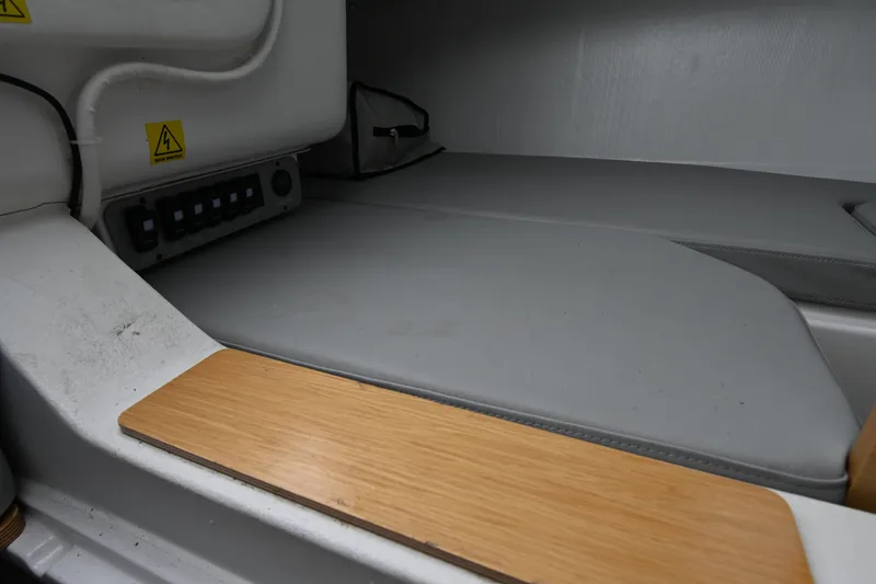 Slide: The Image of Interior view of a 2022 Beneteau First 24 sailboat, featuring a compact cabin space. - 28