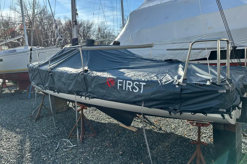 Slide: The Image of 2022 Beneteau First 24 sailboat covered, on stands, in a boatyard. - 34