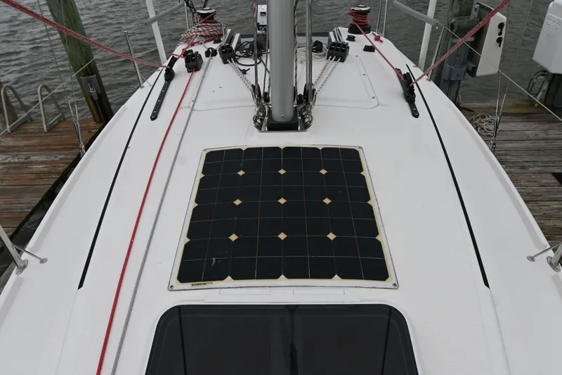 Slide: The Image of 2022 Beneteau First 24 sailboat deck with solar panel and rigging details. - 5
