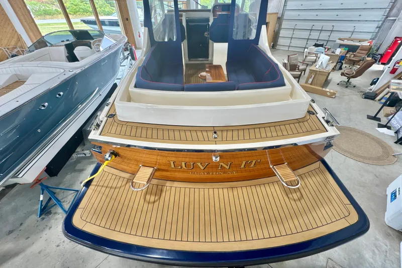 Slide: The Image of 2024 DaVinci 30HT boat with teak deck, docked in a spacious indoor marina. - 32