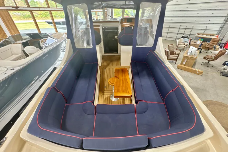 Slide: The Image of 2024 DaVinci 30HT boat interior with blue seating and wooden table. - 33