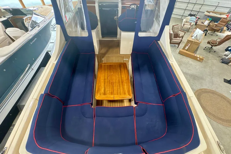 Slide: The Image of Interior of 2024 DaVinci 30HT boat with blue seating and wooden table. - 34