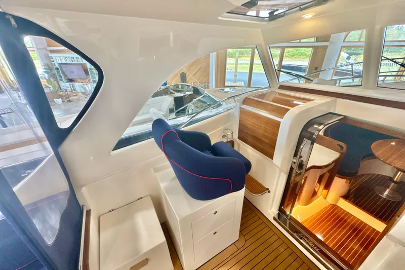 Slide: The Image of 2024 DaVinci 30HT yacht interior with modern helm, wooden accents, and elegant seating. - 37