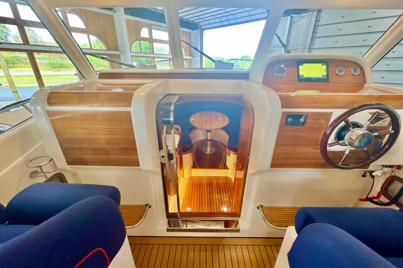 Slide: The Image of Interior of 2024 DaVinci 30HT boat with wooden accents and modern controls. - 44