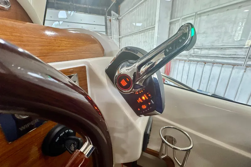 Slide: The Image of Control panel of 2024 DaVinci 30HT boat with steering wheel and throttle lever. - 51