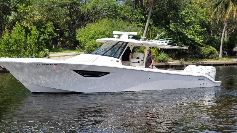 Slide: The Image of 2021 Pursuit S 378 Sport boat cruising on a calm river. - 1
