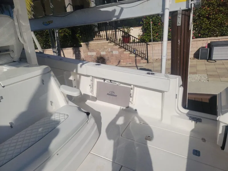 Slide: The Image of 2021 Pursuit S 378 Sport boat interior with seating and storage. - 33