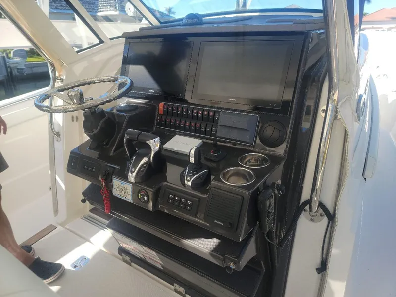 Slide: The Image of 2021 Pursuit S 378 Sport boat dashboard with advanced controls and navigation screens. - 34