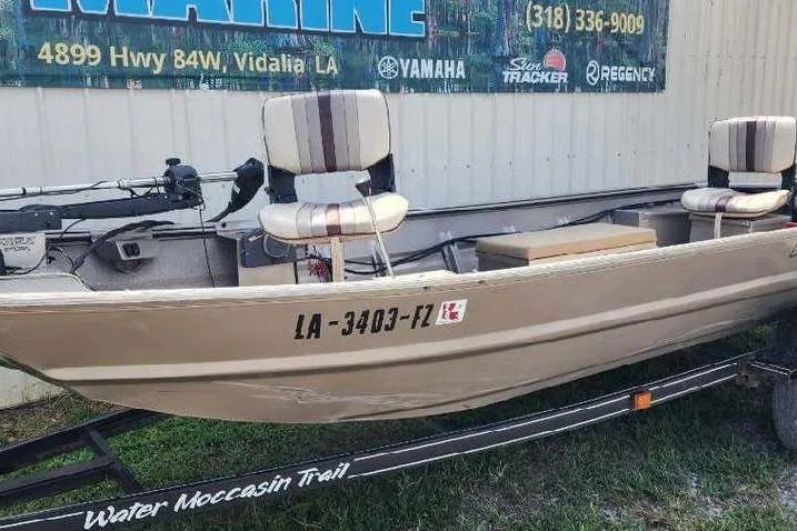 Slide: The Image of 2012 War Eagle 1642 Stick Steer boat on trailer, beige color, striped seats, Louisiana registration. - 5