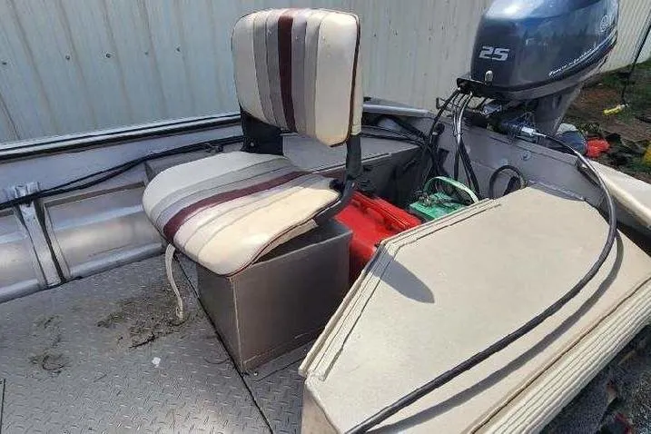 Slide: The Image of 2012 War Eagle 1642 Stick Steer boat interior with seat and outboard motor. - 9