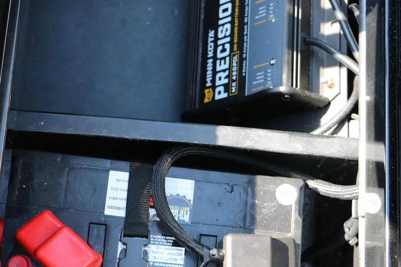 Slide: The Image of 2024 Vexus VXS 20 boat battery compartment with Minn Kota Precision charger. - 39