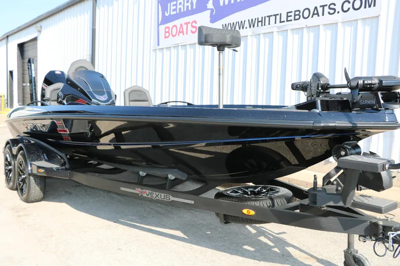 Slide: The Image of 2024 Vexus VXS 20 boat in black, parked outside Whittle Boats dealership. - 4