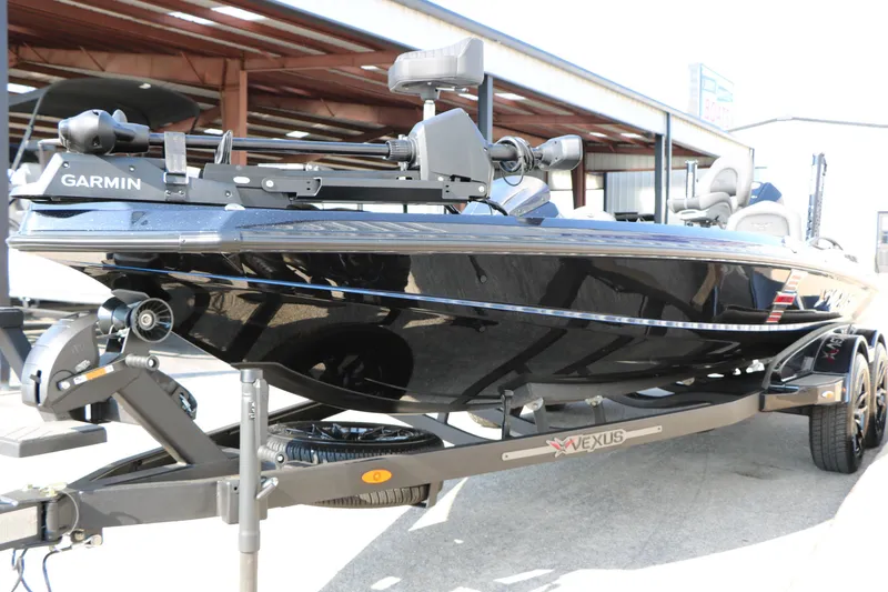 Slide: The Image of 2024 Vexus VXS 20 boat with Garmin equipment on a trailer, parked outdoors. - 5