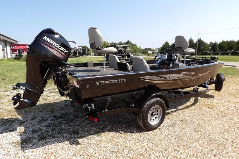 Slide: The Image of 2013 Lowe Stinger ST175 boat with Mercury engine on a trailer, parked outdoors. - 10
