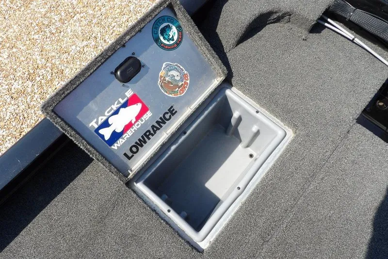 Slide: The Image of Open storage compartment on 2013 Lowe Stinger ST175 boat with fishing stickers. - 11