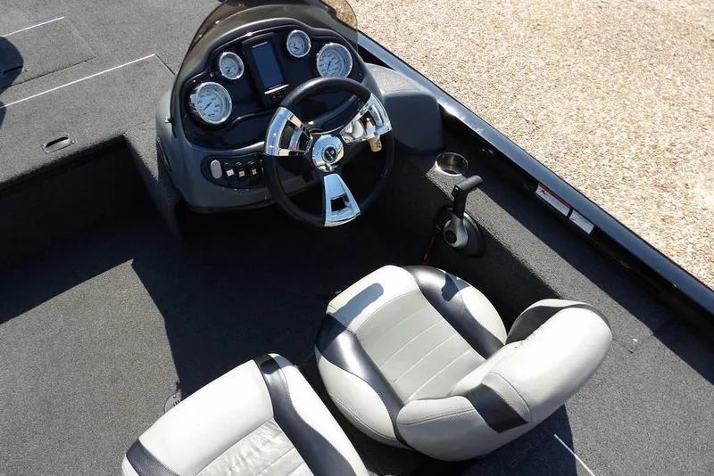 Slide: The Image of 2013 Lowe Stinger ST175 boat cockpit with steering wheel and gauges. - 16