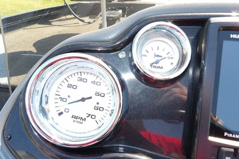 Slide: The Image of Dashboard of a 2013 Lowe Stinger ST175 boat with RPM and trim gauges. - 17