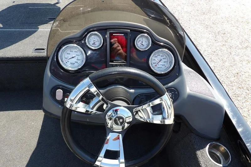 Slide: The Image of Dashboard of a 2013 Lowe Stinger ST175 boat with chrome steering wheel and gauges. - 18