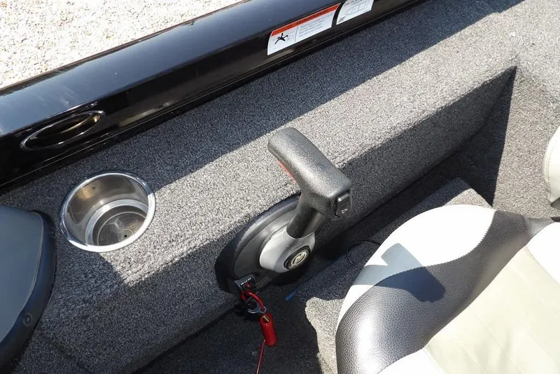 Slide: The Image of 2013 Lowe Stinger ST175 boat interior with cup holder and control lever. - 23