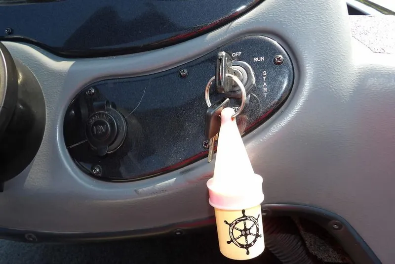 Slide: The Image of Ignition switch of 2013 Lowe Stinger ST175 boat with keychain and nautical design. - 24