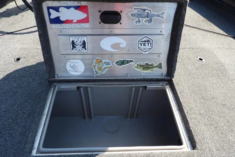 Slide: The Image of 2013 Lowe Stinger ST175 boat storage compartment with various fishing-themed stickers. - 27