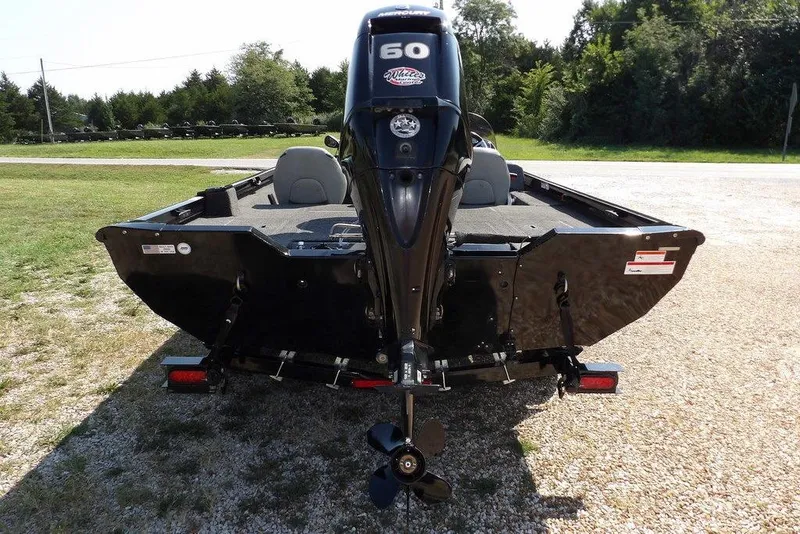 Slide: The Image of 2013 Lowe Stinger ST175 boat with 60 HP outboard motor, parked on gravel. - 3