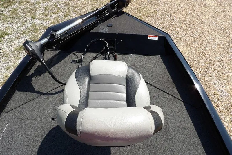 Slide: The Image of 2013 Lowe Stinger ST175 boat interior with a gray seat and trolling motor. - 33