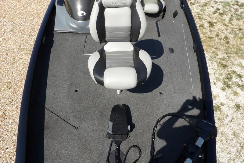 Slide: The Image of 2013 Lowe Stinger ST175 boat interior with gray seating and carpeted deck. - 35