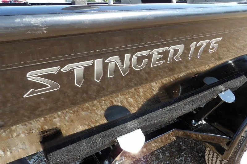 Slide: The Image of 2013 Lowe Stinger ST175 boat side view with logo detail. - 38