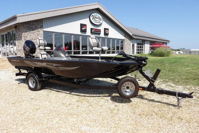 Slide: The Image of 2013 Lowe Stinger ST175 boat on trailer outside marine center. - 45