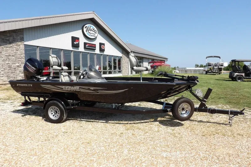 Slide: The Image of 2013 Lowe Stinger ST175 boat on trailer outside marine center. - 46