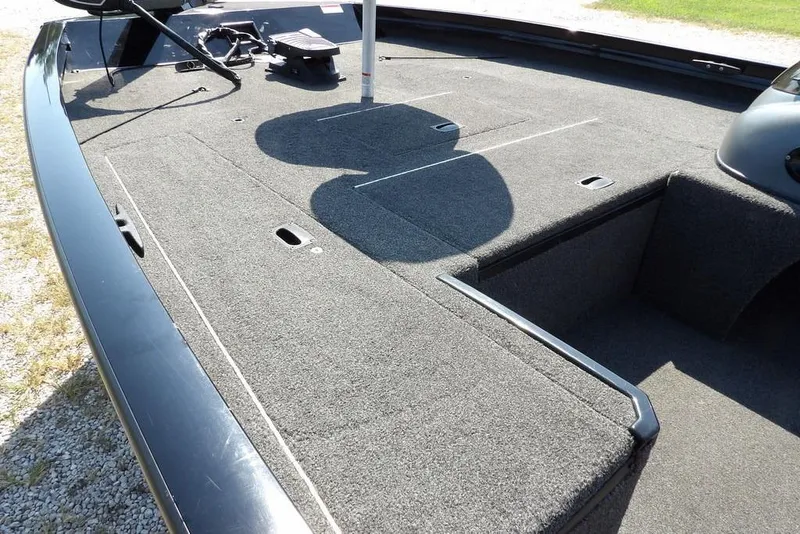 Slide: The Image of 2013 Lowe Stinger ST175 boat deck with carpeted surface and storage compartments. - 6