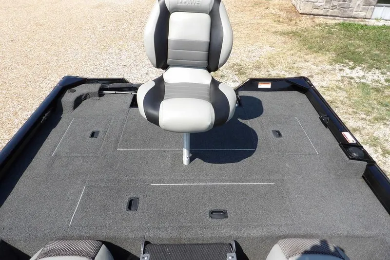 Slide: The Image of 2013 Lowe Stinger ST175 boat interior with a central swivel seat on a carpeted deck. - 7