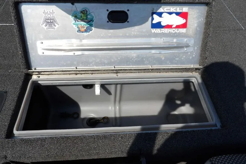Slide: The Image of Open storage compartment on 2013 Lowe Stinger ST175 boat with stickers on lid. - 9