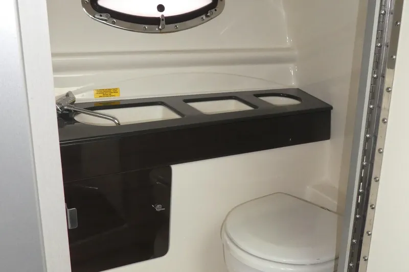 Slide: The Image of 2014 Formula 290 Sun Sport boat bathroom interior with sink and toilet. - 11