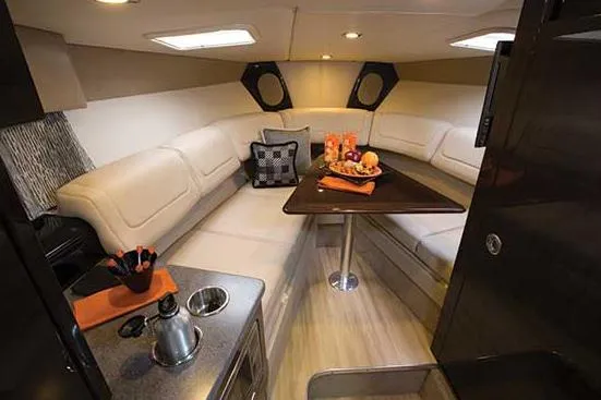 Slide: The Image of Manufacturer Provided Image: 2014 Formula 290 Sun Sport cabin interior with seating area and kitchenette. - 20