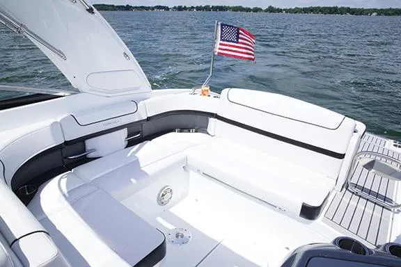 Slide: The Image of Manufacturer Provided Image: 2014 Formula 290 Sun Sport boat interior with American flag on a lake. - 22