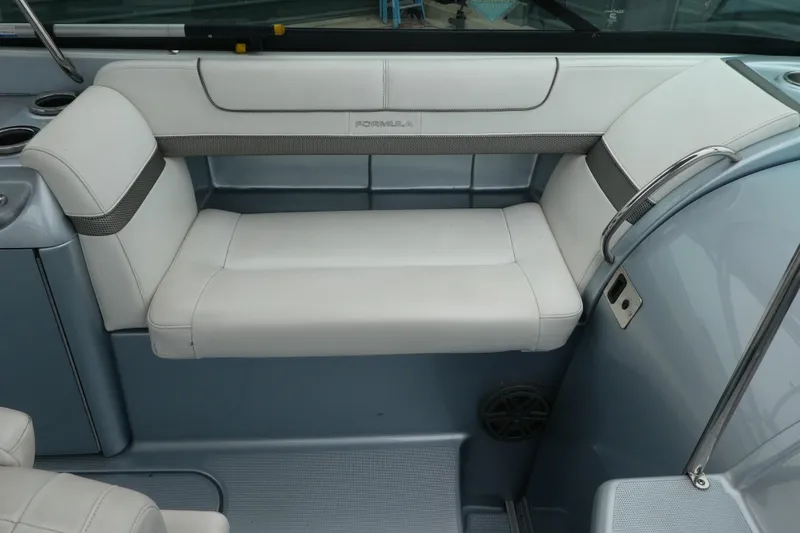 Slide: The Image of 2014 Formula 290 Sun Sport boat interior with white cushioned seating. - 8