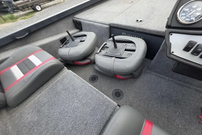 Slide: The Image of 2022 Ranger RT188P boat interior with gray and red seats, steering controls, and dashboard. - 16