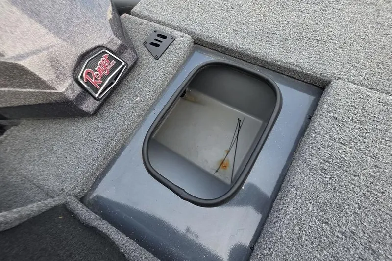 Slide: The Image of 2022 Ranger RT188P boat storage compartment with carpeted interior and Ranger logo. - 17