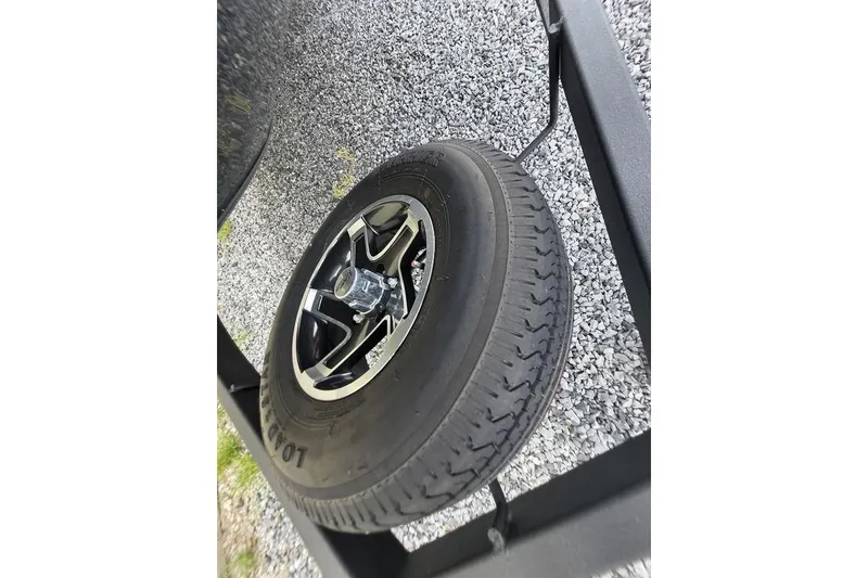 Slide: The Image of 2022 Ranger RT188P trailer tire on gravel surface, showcasing alloy wheel design. - 18