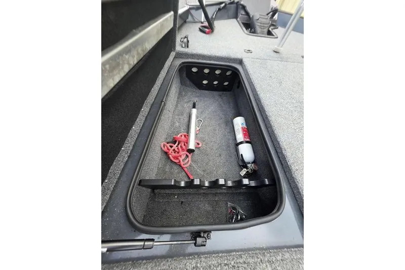 Slide: The Image of 2022 Ranger RT188P boat storage compartment with safety equipment and red rope. - 23