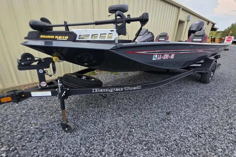 Slide: The Image of 2022 Ranger RT188P boat on trailer, featuring Minn Kota motor, parked on gravel. - 3