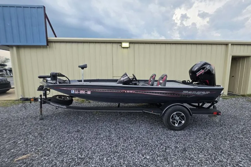 Slide: The Image of 2022 Ranger RT188P boat on trailer, parked outside a beige building. - 4